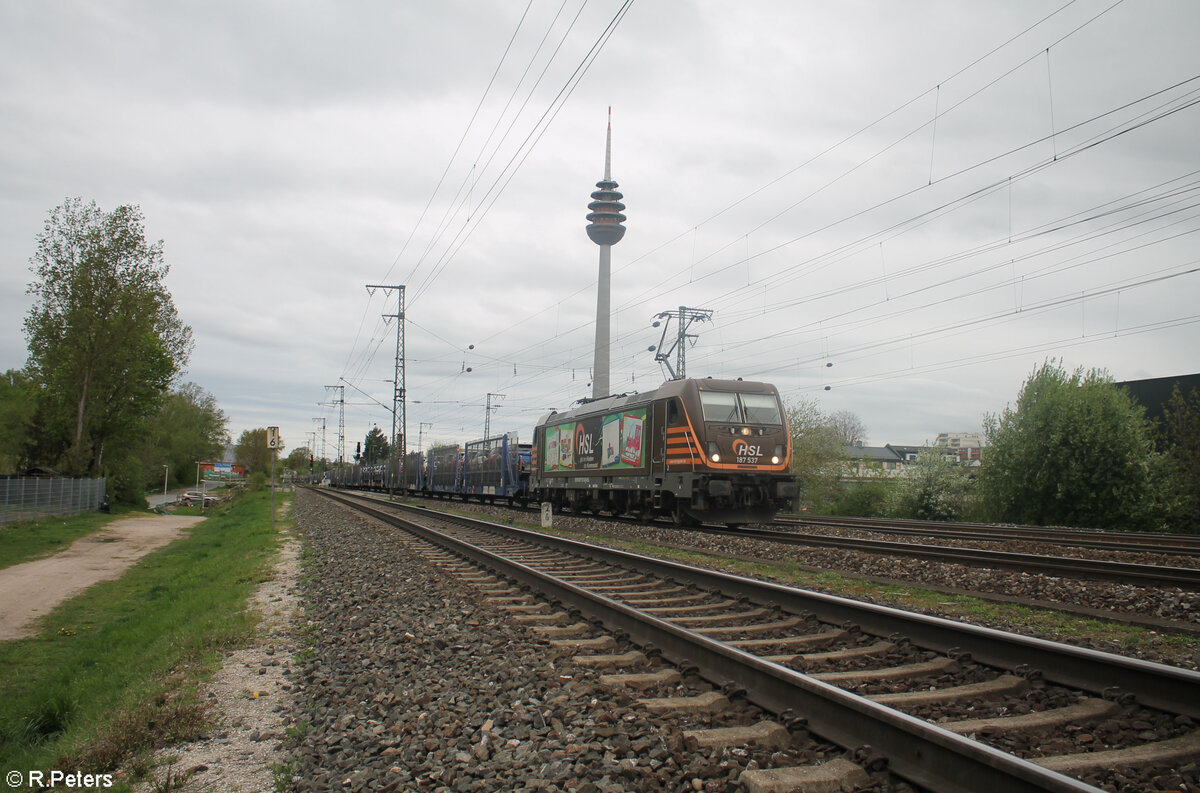 187 537-6  Gebt den Kindern das Kommando  zieht mit einem Hödlmayer Autotransportzug durch Nürnberg Hohe Marter. 09.04.24