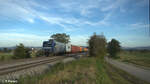 145 028-7 zieht mit einem Containerzug bei Pölling in Richtung Norden. 17.10.24